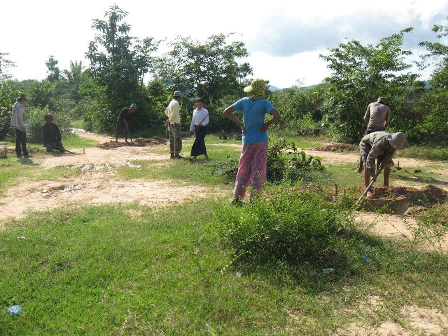 Group of people working on construction site in rural area