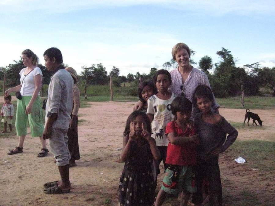 Group of volunteers and Cambodian children posing together