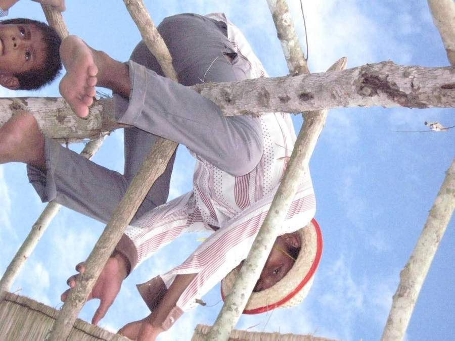 Young person balancing on wooden poles of structure