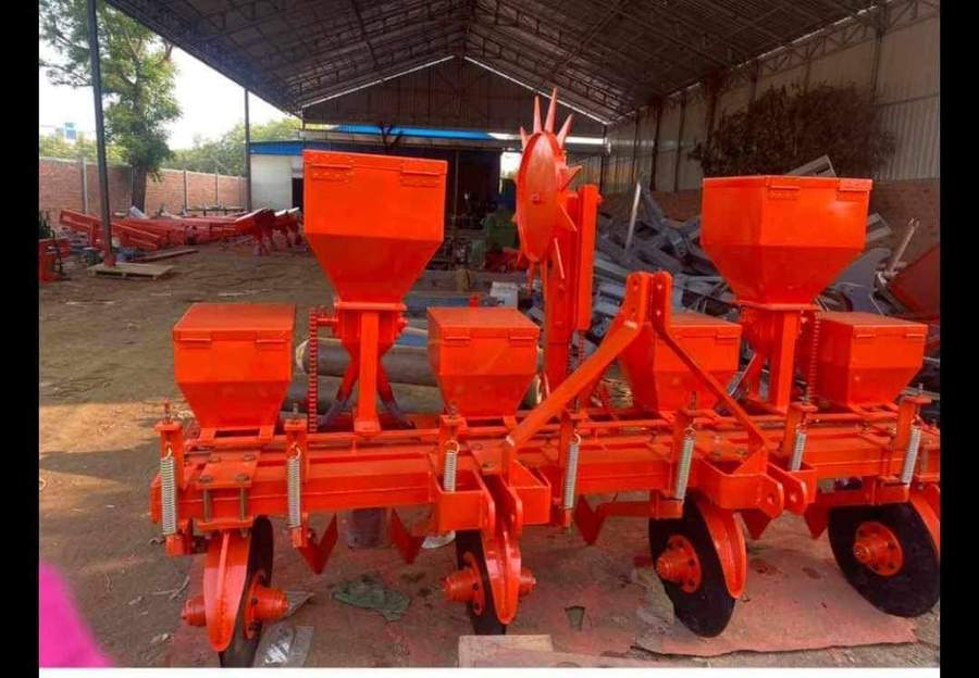 Orange agricultural planting machine with multiple seed hoppers