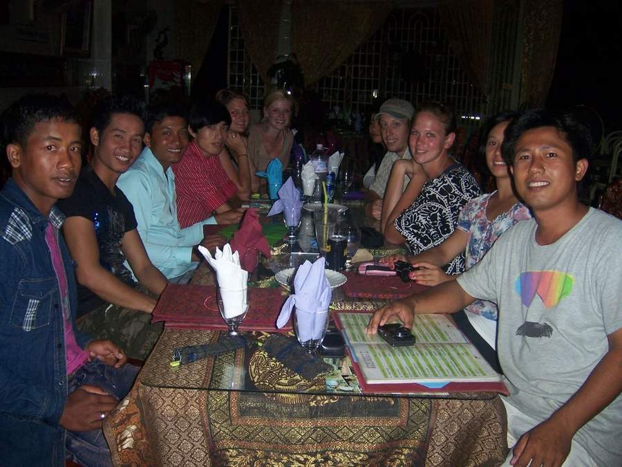 Group at restaurant table with folded napkins and drinks