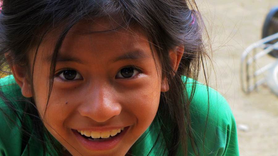 Close-up of smiling girl in green shirt
